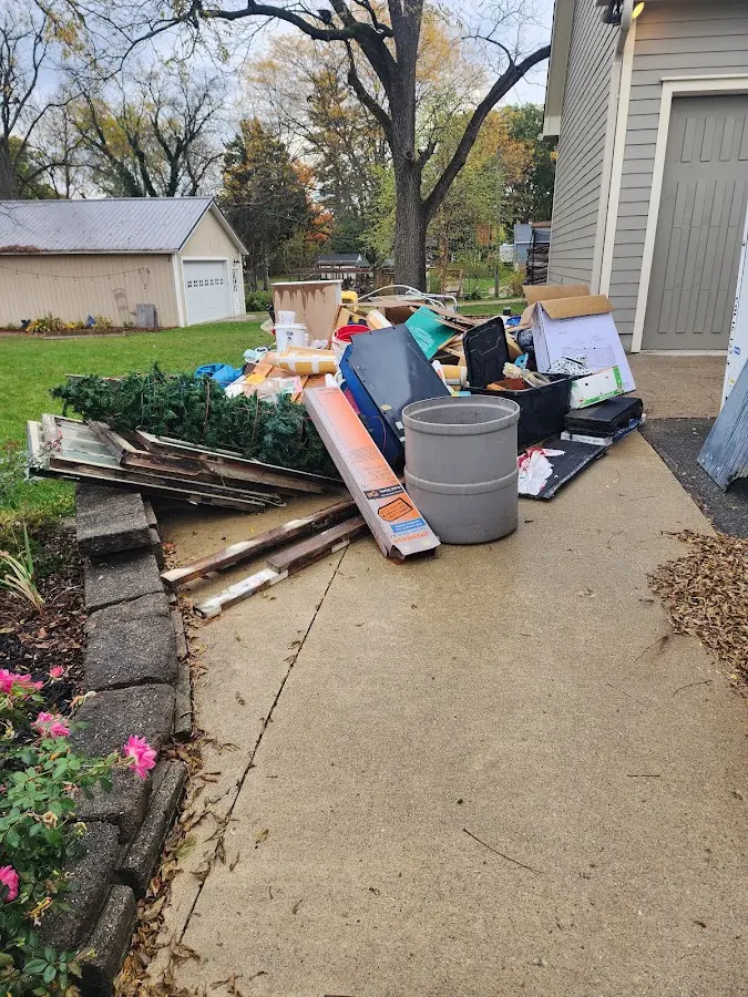 Dumpster being loaded with debris for 12 Yard Dumpster Rental in Westford
